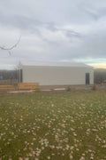 Double steel garage with roll-up doors, outdoor view

Interior view of metal garage barn frame

Roll-up electric overhead doors included in garage

Galvanized steel shed for vehicle and farm storage

Multiple-size all-weather garage options