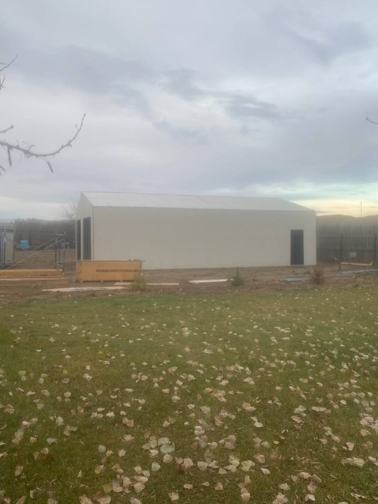 Double steel garage with roll-up doors, outdoor view

Interior view of metal garage barn frame

Roll-up electric overhead doors included in garage

Galvanized steel shed for vehicle and farm storage

Multiple-size all-weather garage options