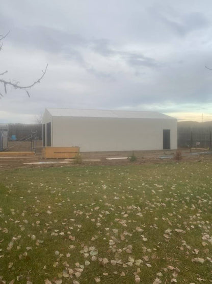 Double steel garage with roll-up doors, outdoor view

Interior view of metal garage barn frame

Roll-up electric overhead doors included in garage

Galvanized steel shed for vehicle and farm storage

Multiple-size all-weather garage options