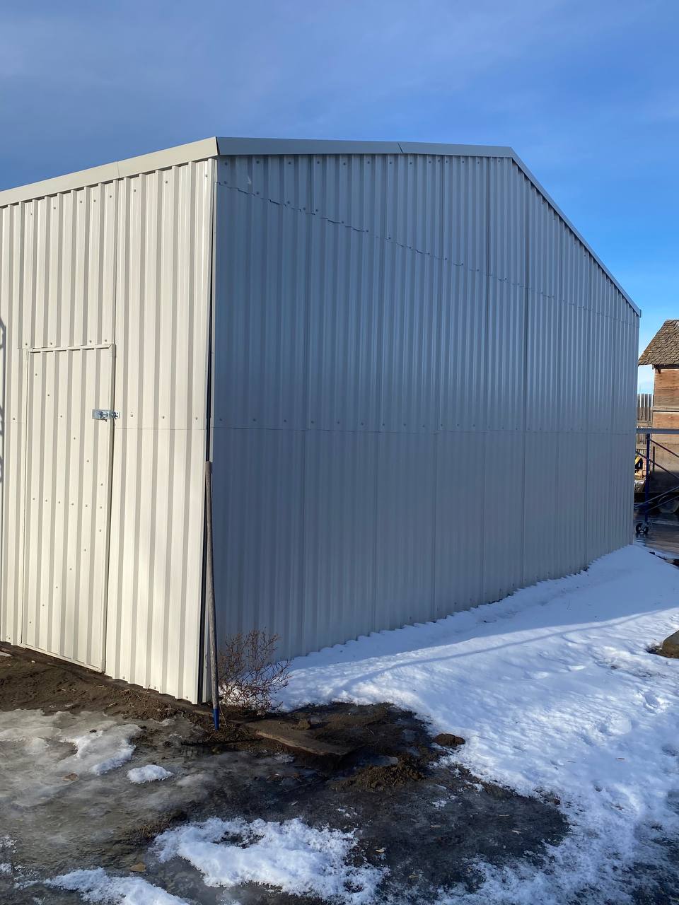 Double steel garage with roll-up doors, outdoor view

Interior view of metal garage barn frame

Roll-up electric overhead doors included in garage

Galvanized steel shed for vehicle and farm storage

Multiple-size all-weather garage options