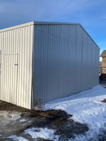 Double steel garage with roll-up doors, outdoor view

Interior view of metal garage barn frame

Roll-up electric overhead doors included in garage

Galvanized steel shed for vehicle and farm storage

Multiple-size all-weather garage options