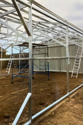 Double steel garage with roll-up doors, outdoor view

Interior view of metal garage barn frame

Roll-up electric overhead doors included in garage

Galvanized steel shed for vehicle and farm storage

Multiple-size all-weather garage options