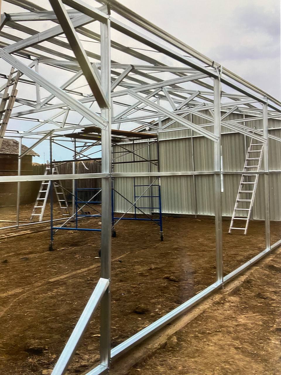 Double steel garage with roll-up doors, outdoor view

Interior view of metal garage barn frame

Roll-up electric overhead doors included in garage

Galvanized steel shed for vehicle and farm storage

Multiple-size all-weather garage options