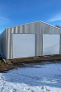 Double steel garage with roll-up doors, outdoor view

Interior view of metal garage barn frame

Roll-up electric overhead doors included in garage

Galvanized steel shed for vehicle and farm storage

Multiple-size all-weather garage options