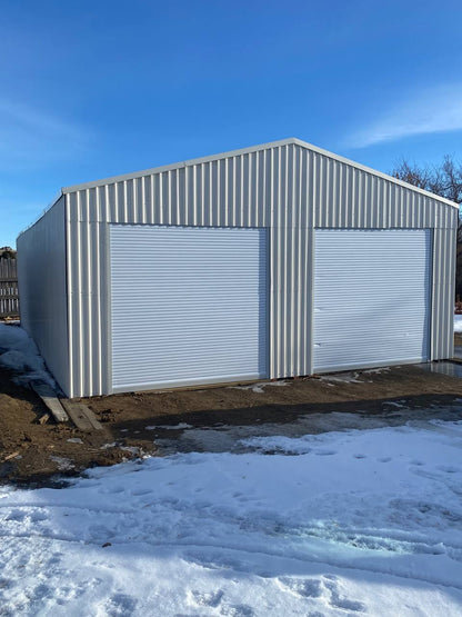 Double steel garage with roll-up doors, outdoor view

Interior view of metal garage barn frame

Roll-up electric overhead doors included in garage

Galvanized steel shed for vehicle and farm storage

Multiple-size all-weather garage options