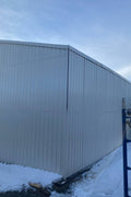 Double steel garage with roll-up doors, outdoor view

Interior view of metal garage barn frame

Roll-up electric overhead doors included in garage

Galvanized steel shed for vehicle and farm storage

Multiple-size all-weather garage options