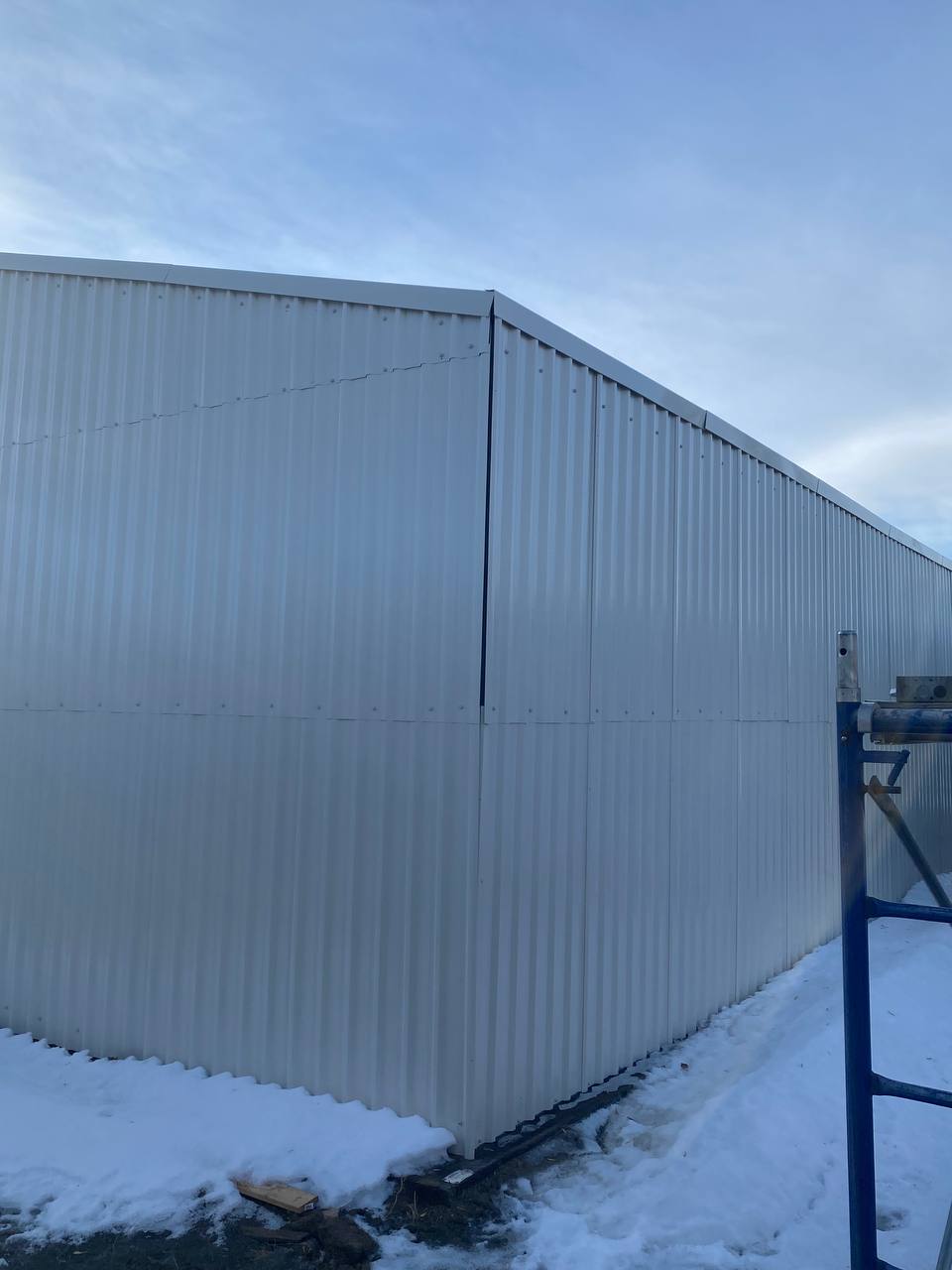 Double steel garage with roll-up doors, outdoor view

Interior view of metal garage barn frame

Roll-up electric overhead doors included in garage

Galvanized steel shed for vehicle and farm storage

Multiple-size all-weather garage options