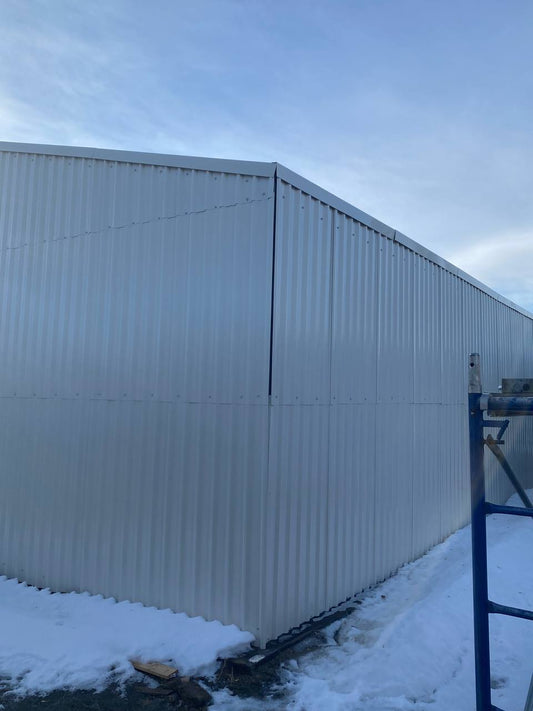 Double steel garage with roll-up doors, outdoor view

Interior view of metal garage barn frame

Roll-up electric overhead doors included in garage

Galvanized steel shed for vehicle and farm storage

Multiple-size all-weather garage options