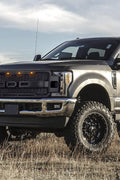 Installed front grille on F-250 (front view)
LED lights illuminated on grille
Full grille kit with components displayed
Side angle showcasing grille on truck
Top-down view of grille material and mesh
Before and after install comparison
Close-up of amber LED bar in grille