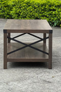 Gray wash rustic coffee table with metal X-frame in the living room
Front view of the coffee table showing shelf storage
Side angle showing gray tabletop and open shelf
Coffee table outdoors with accessories
Detail of gray wash wood and black frame