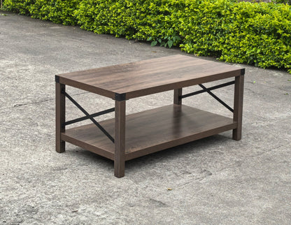Gray wash rustic coffee table with metal X-frame in the living room
Front view of the coffee table showing shelf storage
Side angle showing gray tabletop and open shelf
Coffee table outdoors with accessories
Detail of gray wash wood and black frame