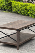 Gray wash rustic coffee table with metal X-frame in the living room
Front view of the coffee table showing shelf storage
Side angle showing gray tabletop and open shelf
Coffee table outdoors with accessories
Detail of gray wash wood and black frame