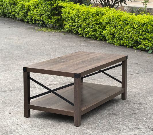 Gray wash rustic coffee table with metal X-frame in the living room
Front view of the coffee table showing shelf storage
Side angle showing gray tabletop and open shelf
Coffee table outdoors with accessories
Detail of gray wash wood and black frame