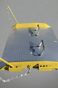 Heavy-duty steel loading dock ramp on warehouse floor

Industrial dock ramp with yellow safety rails

Forklift-ready steel dock board in use

Side view of 15,000 lb steel dock ramp

Loading dock ramp with chain attachment system
