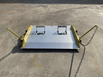 Heavy-duty steel loading dock ramp on warehouse floor

Industrial dock ramp with yellow safety rails

Forklift-ready steel dock board in use

Side view of 15,000 lb steel dock ramp

Loading dock ramp with chain attachment system
