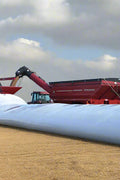 10 ft x 300 ft heavy duty grain bag filled with corn on a farm field
Polyethylene grain bag used for temporary harvest storage
Farm equipment loading grain into a 10 mil white grain bag
UV-protected 10 mil grain storage bag on rural property