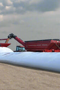 10 ft x 300 ft heavy duty grain bag filled with corn on a farm field
Polyethylene grain bag used for temporary harvest storage
Farm equipment loading grain into a 10 mil white grain bag
UV-protected 10 mil grain storage bag on rural property