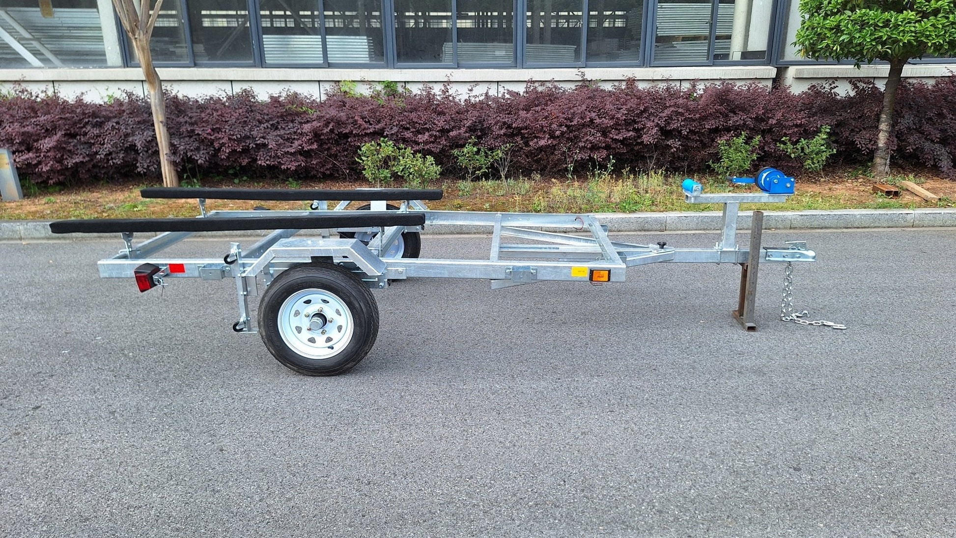 Heavy-duty galvanized 4x8 folding utility trailer with checker plate deck and road-ready tires