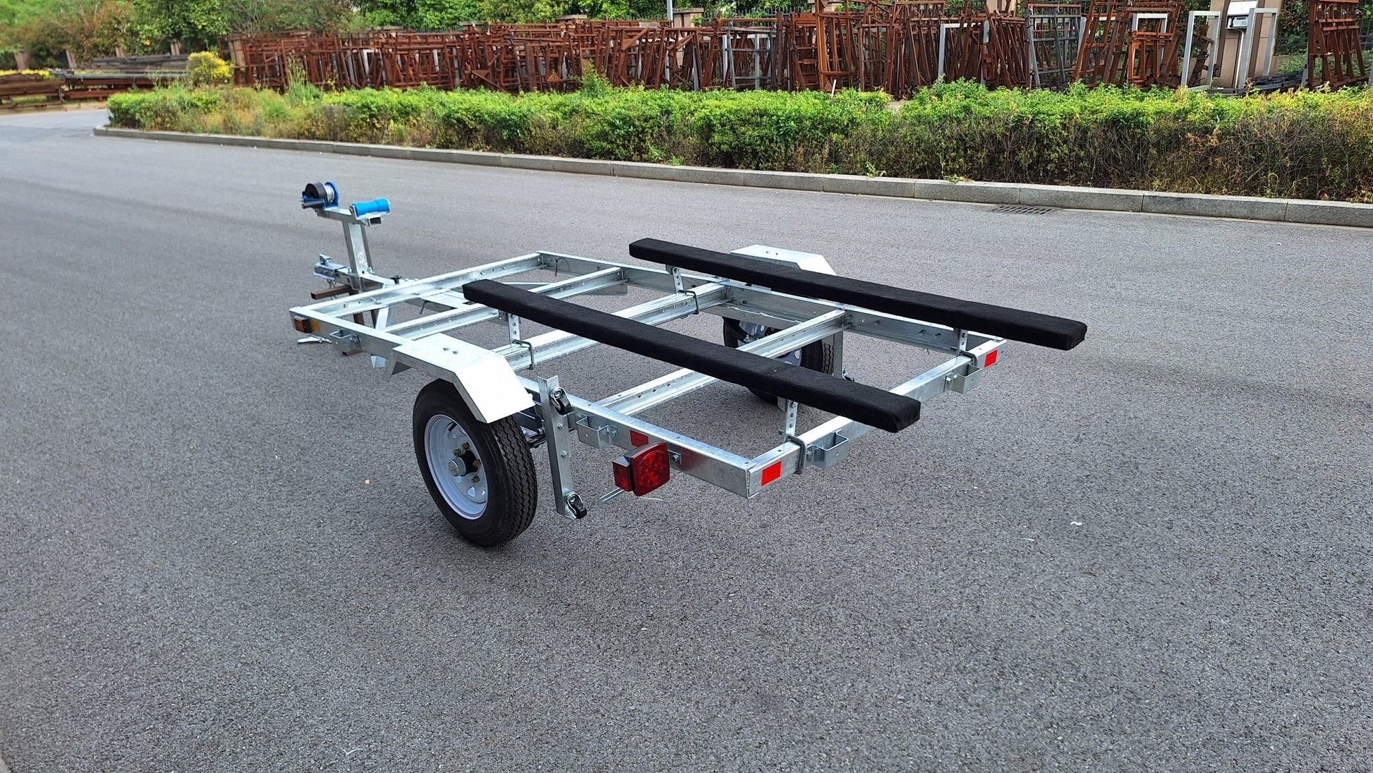 Heavy-duty galvanized 4x8 folding utility trailer with checker plate deck and road-ready tires