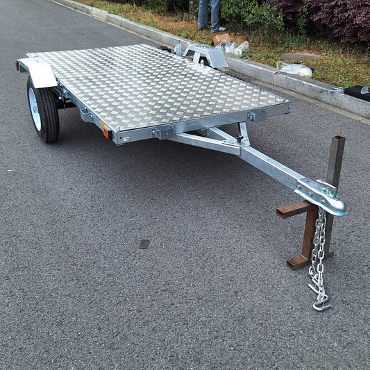 Heavy-duty galvanized 4x8 folding utility trailer with checker plate deck and road-ready tires