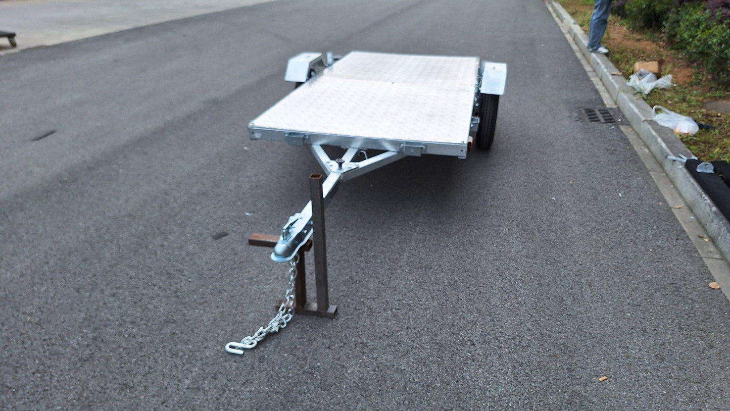 Heavy-duty galvanized 4x8 folding utility trailer with checker plate deck and road-ready tires