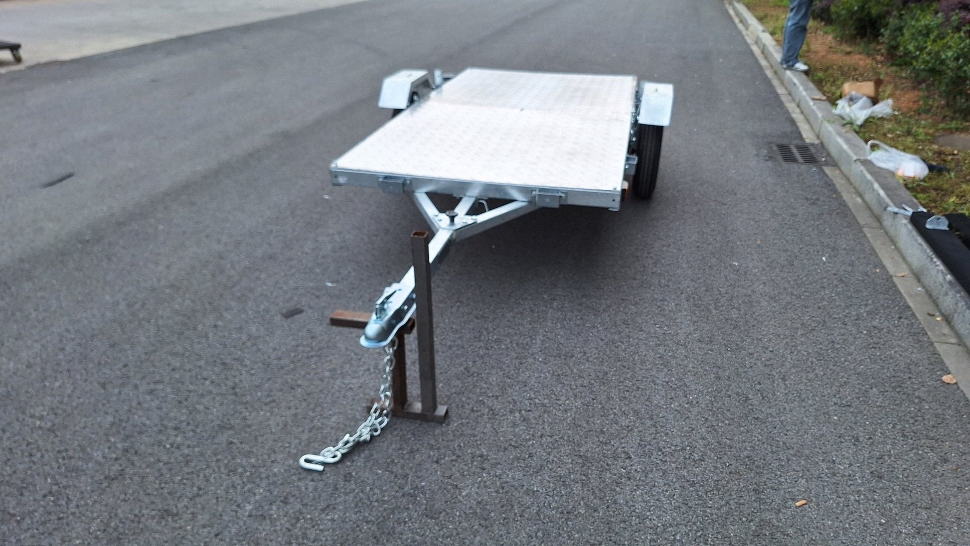Heavy-duty galvanized 4x8 folding utility trailer with checker plate deck and road-ready tires