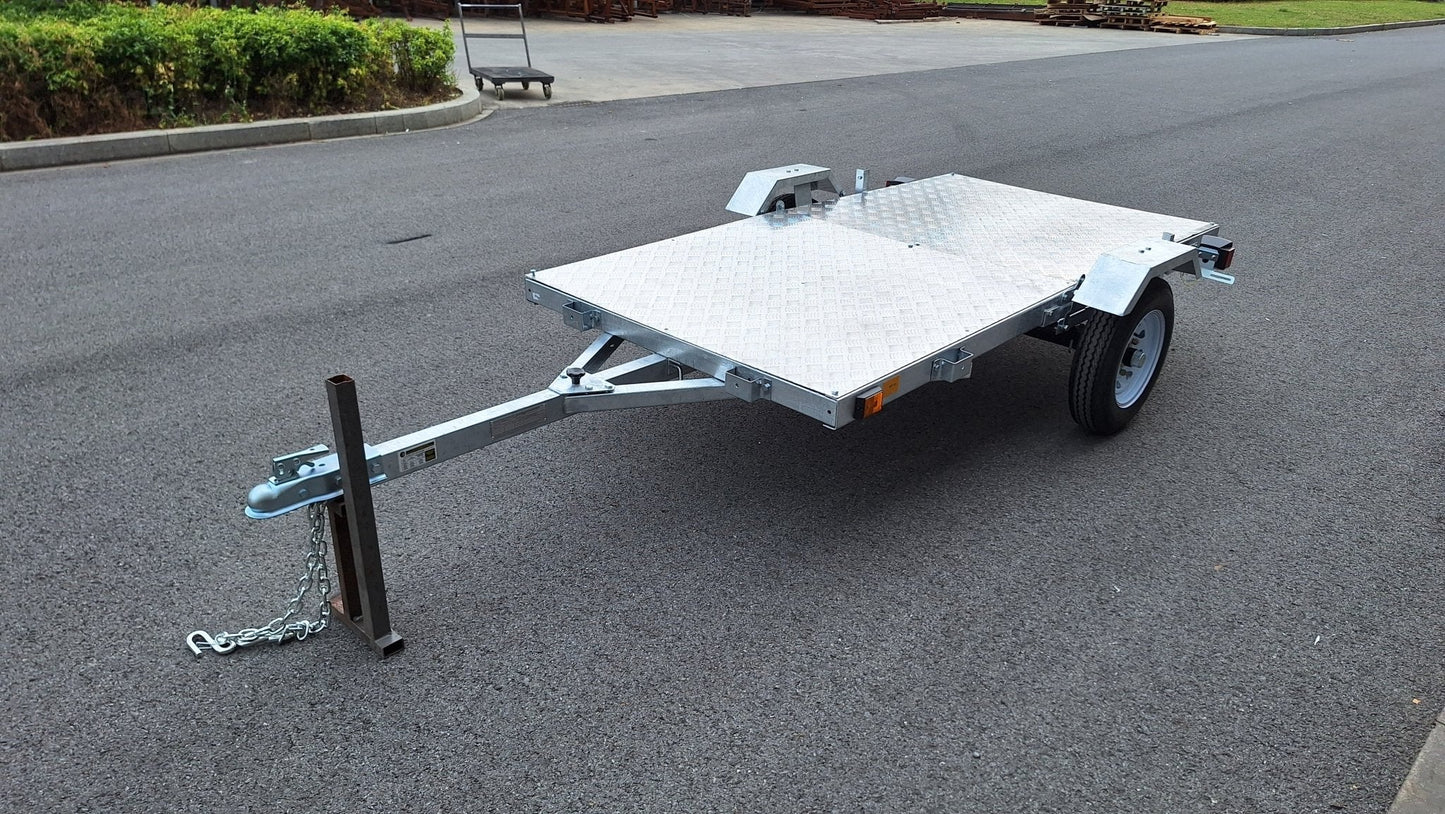Heavy-duty galvanized 4x8 folding utility trailer with checker plate deck and road-ready tires