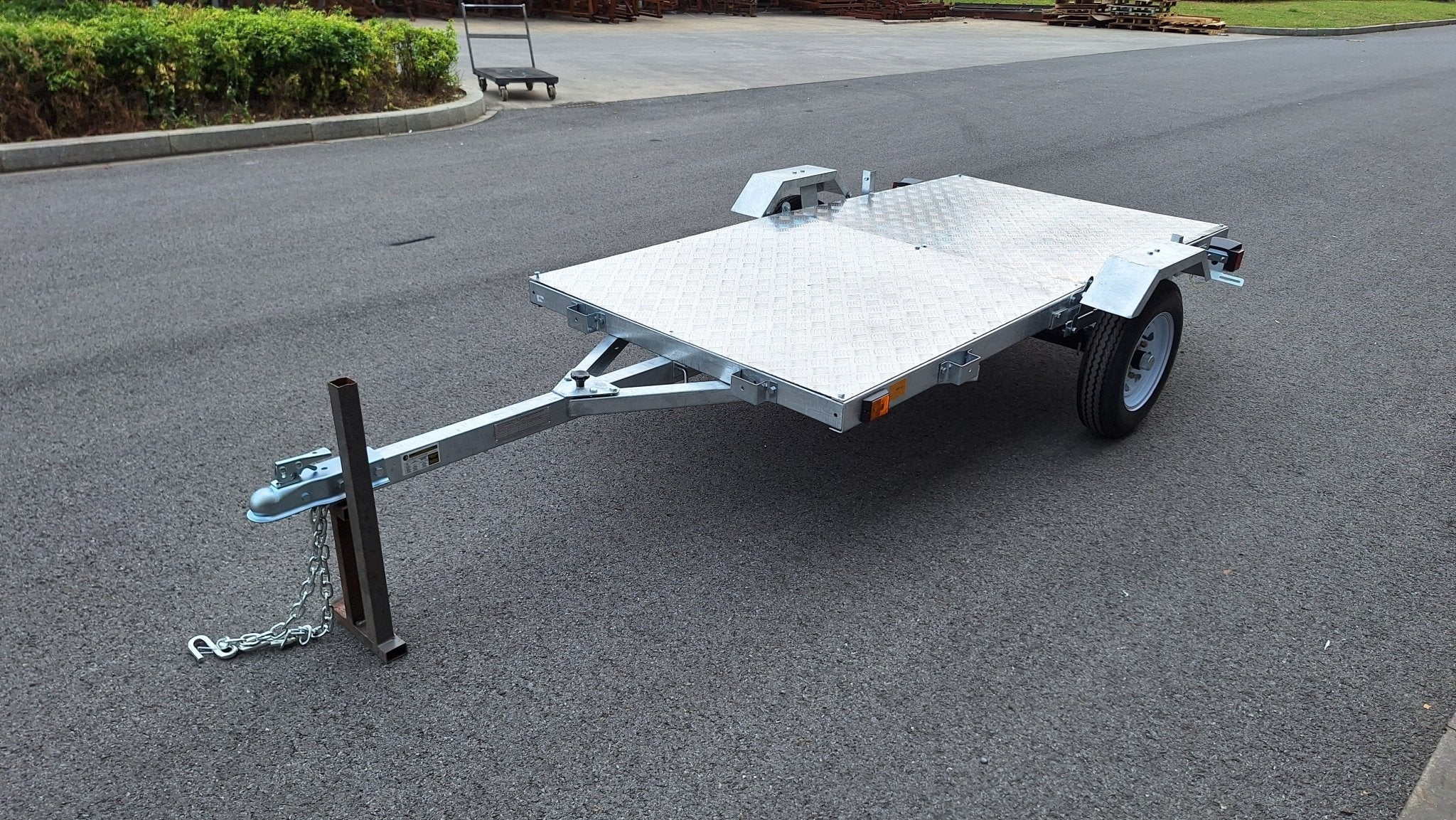 Heavy-duty galvanized 4x8 folding utility trailer with checker plate deck and road-ready tires