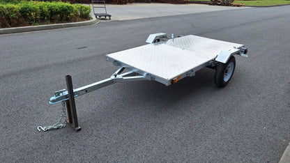 Heavy-duty galvanized 4x8 folding utility trailer with checker plate deck and road-ready tires
