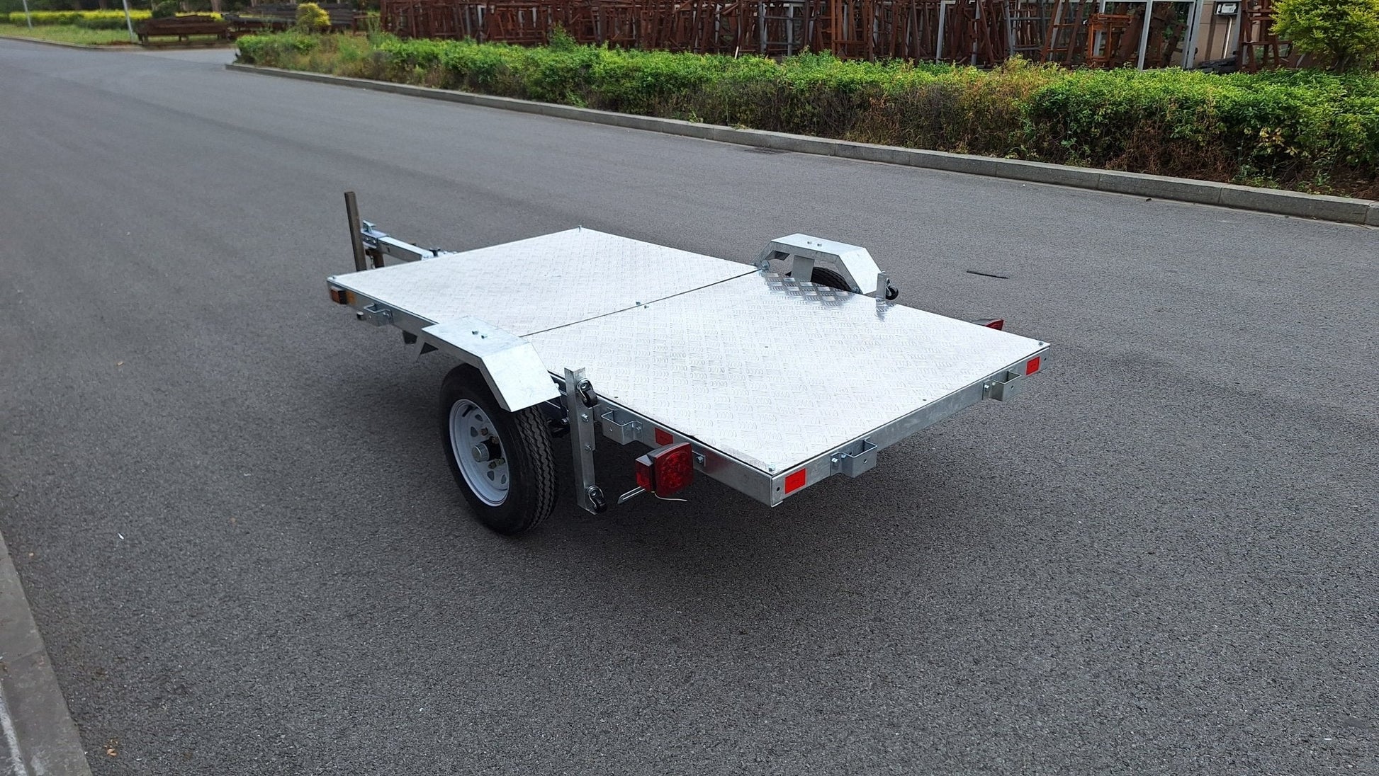 Heavy-duty galvanized 4x8 folding utility trailer with checker plate deck and road-ready tires