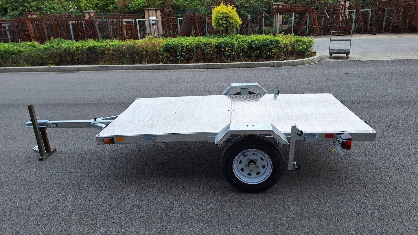 Heavy-duty galvanized 4x8 folding utility trailer with checker plate deck and road-ready tires