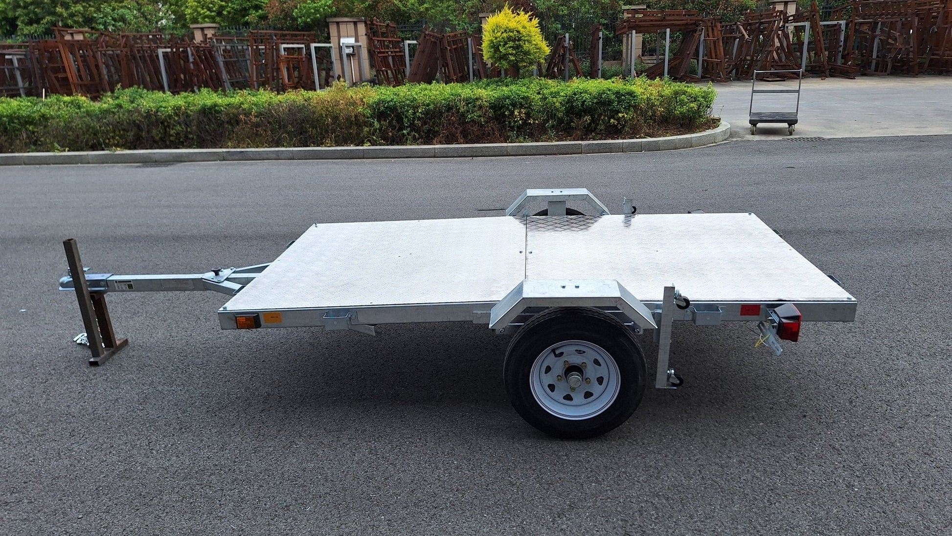 Heavy-duty galvanized 4x8 folding utility trailer with checker plate deck and road-ready tires