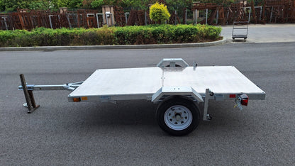 Heavy-duty galvanized 4x8 folding utility trailer with checker plate deck and road-ready tires