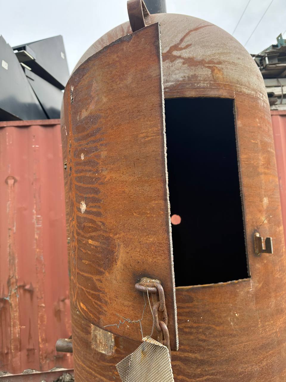 “7.5 ft tall steel garbage incinerator with vent stack”

“Industrial burn drum with hinged loading door”

“outdoor incinerator barrel for yard waste and brush”

“heavy-duty steel burn barrel for farm or construction”

“pre-weathered rust-patina waste disposal drum”

