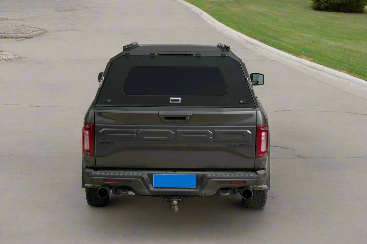 Side view of heavy-duty steel truck topper on black pickup
Modular canopy with open gullwing side door
Lockable utility cap rear view
Installation components of modular truck canopy
Steel topper installed on full-size pickup truck