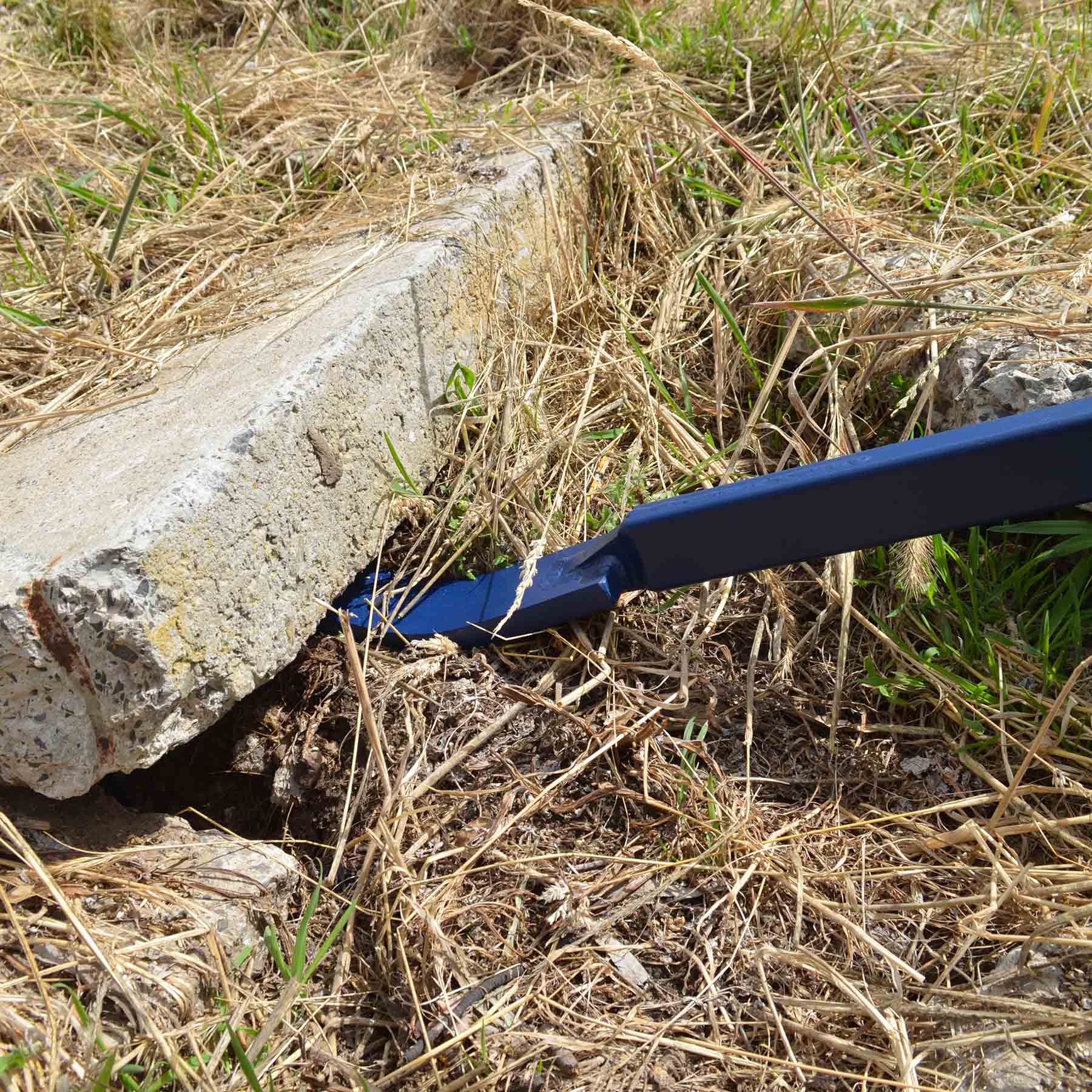 Heavy-duty 46-inch blue pry bar angled view

Pry bar in action pulling concrete formwork

Close-up of beveled tip and rubber handle

Construction site use of pry bar tool