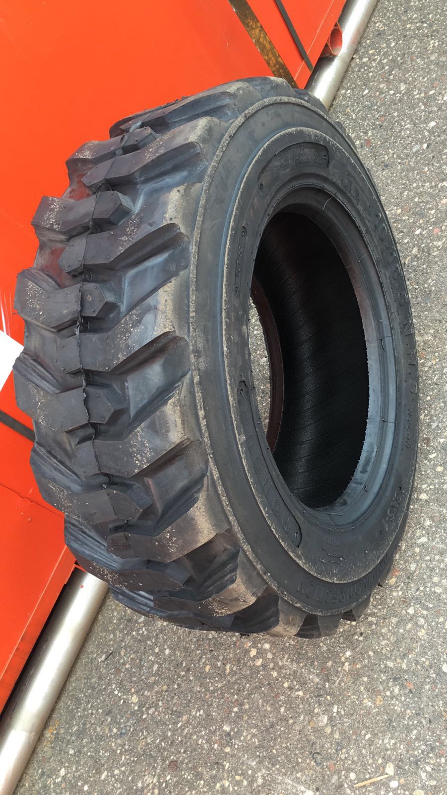 “Heavy duty skid steer tires with aggressive tread”

“SKS-1 and SKS-4 tires for Bobcat A300 and S750”

“Skid steer tires with red and silver rims”

“10x16.5 to 15x19.5 skid steer tire variants”

“Close-up of durable construction skid steer tire”

