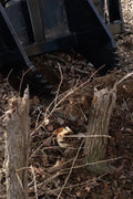 Tree Grubber Attachment front view mounted on skid steer
Close-up of cutting edge removing root
Attachment digging under tree taproot
Brush and root removal tool in action