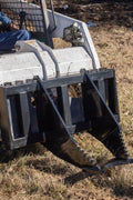 Tree Grubber Attachment front view mounted on skid steer
Close-up of cutting edge removing root
Attachment digging under tree taproot
Brush and root removal tool in action