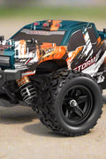 RC truck front view with purple detailing
RC truck side view showing 4WD build
All terrain tires with shock suspension
RC controller and accessories layout
Close-up of motor and battery system
RC truck in action outdoors