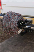 Barbed wire unroller mounted on a hitch
Fence wire roller with ATV adapter
Heavy-duty barbed wire dispenser close-up
Side profile of wire unroller