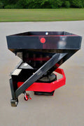 Skid Steer Tilt-N-Scoop Material Spreader front view
Side profile of spreader mounted on skid steer
Hydraulic spreader with sidewalk shield
Top view of hopper and agitator
Spreader attachment in action with sand