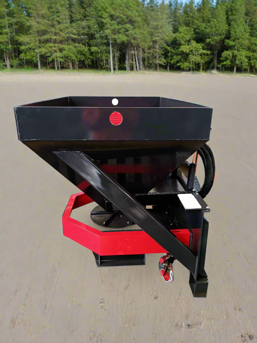 Skid Steer Tilt-N-Scoop Material Spreader front view
Side profile of spreader mounted on skid steer
Hydraulic spreader with sidewalk shield
Top view of hopper and agitator
Spreader attachment in action with sand