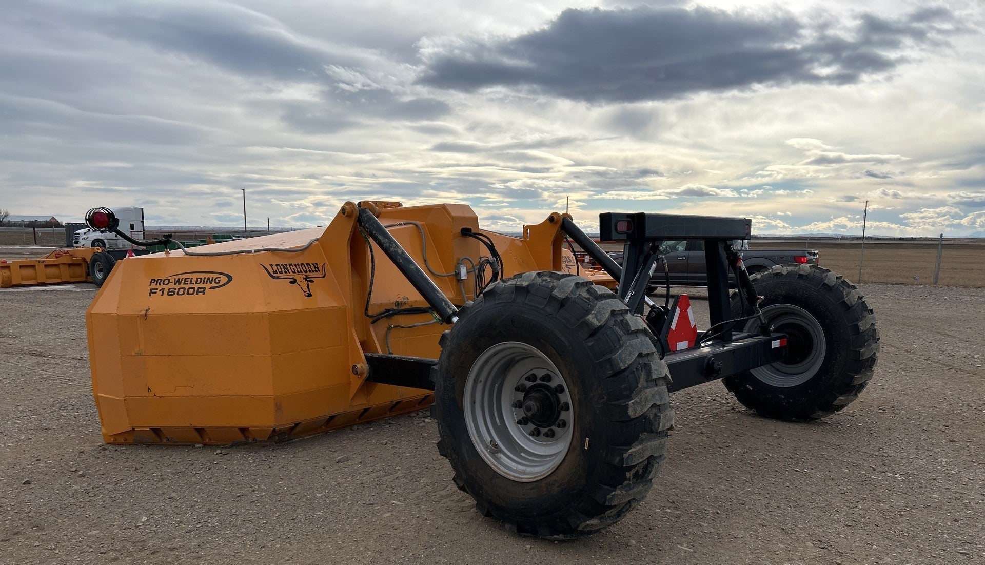 Industries America 16 FT Hydraulic Pull Scraper – Side View on Tractor

Heavy-Duty Orange Scraper with Flotation Tires – Field Ready

16 Foot U-Blade Hydraulic Scraper for Earthmoving Projects

Tractor Attachment Scraper with Tilt Function – Rear Angle View