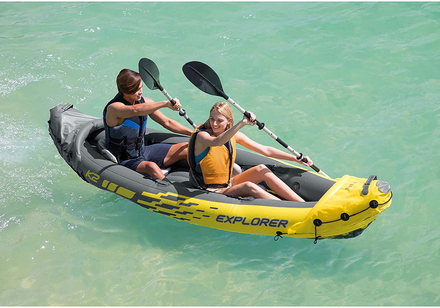 Intex Explorer K2 inflatable kayak on water with paddles

Top view of Explorer K2 kayak with seats and pump

Close-up of inflatable cockpit seats

Full kayak set with oars, pump, and skeg

Explorer K2 in yellow – packaged with accessories