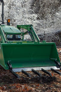 Clamp-on debris fork attachment on black tractor bucket – 60 inch
Green John Deere tractor with clamp-on fork attachment hauling debris
72-inch clamp-on debris forks mounted on front loader