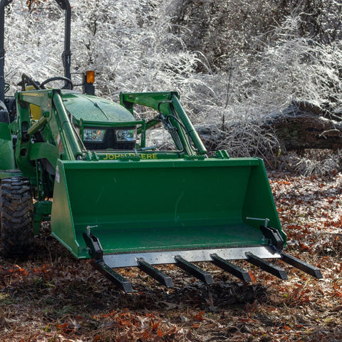 Clamp-on debris fork attachment on black tractor bucket – 60 inch
Green John Deere tractor with clamp-on fork attachment hauling debris
72-inch clamp-on debris forks mounted on front loader
