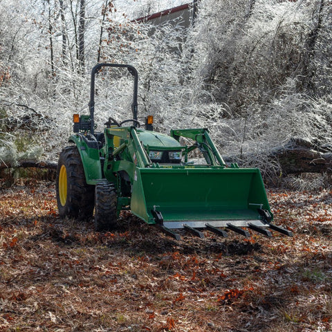 Clamp-on debris fork attachment on black tractor bucket – 60 inch
Green John Deere tractor with clamp-on fork attachment hauling debris
72-inch clamp-on debris forks mounted on front loader