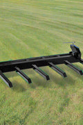Clamp-on debris fork attachment on black tractor bucket – 60 inch
Green John Deere tractor with clamp-on fork attachment hauling debris
72-inch clamp-on debris forks mounted on front loader
