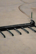 Clamp-on debris fork attachment on black tractor bucket – 60 inch
Green John Deere tractor with clamp-on fork attachment hauling debris
72-inch clamp-on debris forks mounted on front loader